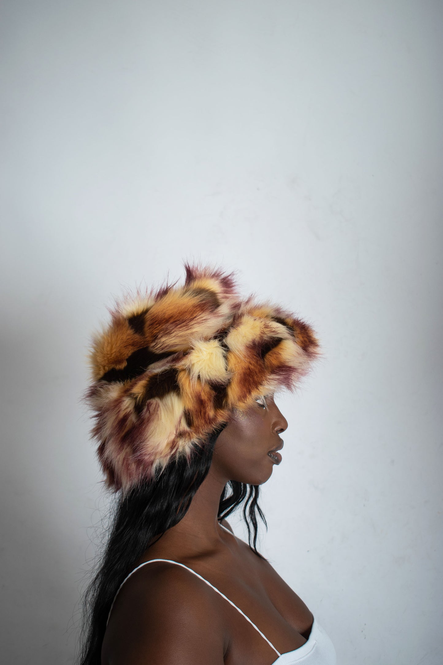 This unique style of hat comes with a blend of colours, Beige, Brown, Cream, Burgundy and Light Burgundy Lining. Handmade from faux fur and duchess satin by Rashhiiid, an Irish fashion business that celebrates individualism and sustainable fashion. This headpiece is a stylish example of alternative fashion design that is both high quality and ethical.