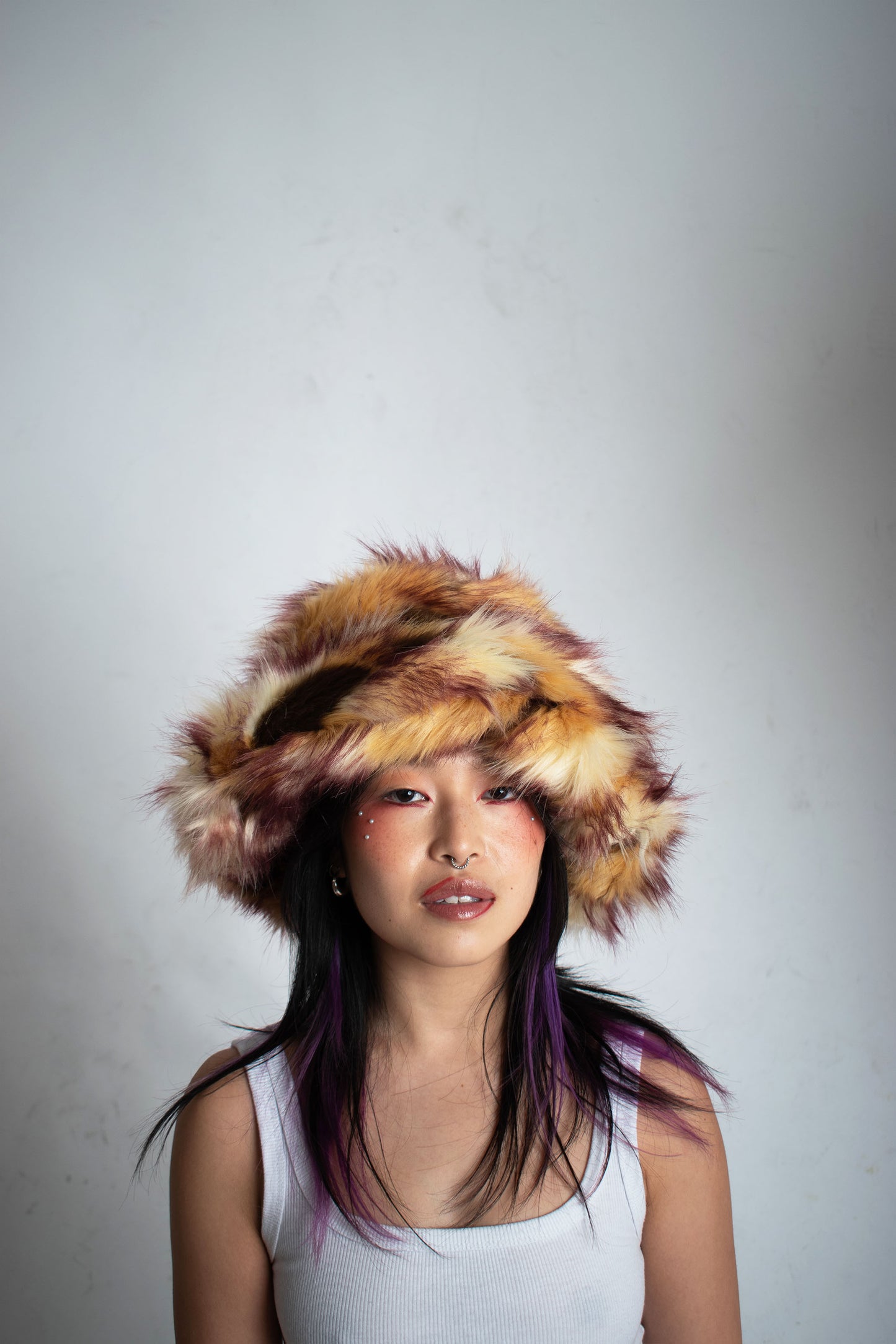 This unique style of hat comes with a blend of colours, Beige, Brown, Cream, Burgundy and Light Burgundy Lining. Handmade from faux fur and duchess satin by Rashhiiid, an Irish fashion business that celebrates individualism and sustainable fashion. This headpiece is a stylish example of alternative fashion design that is both high quality and ethical.