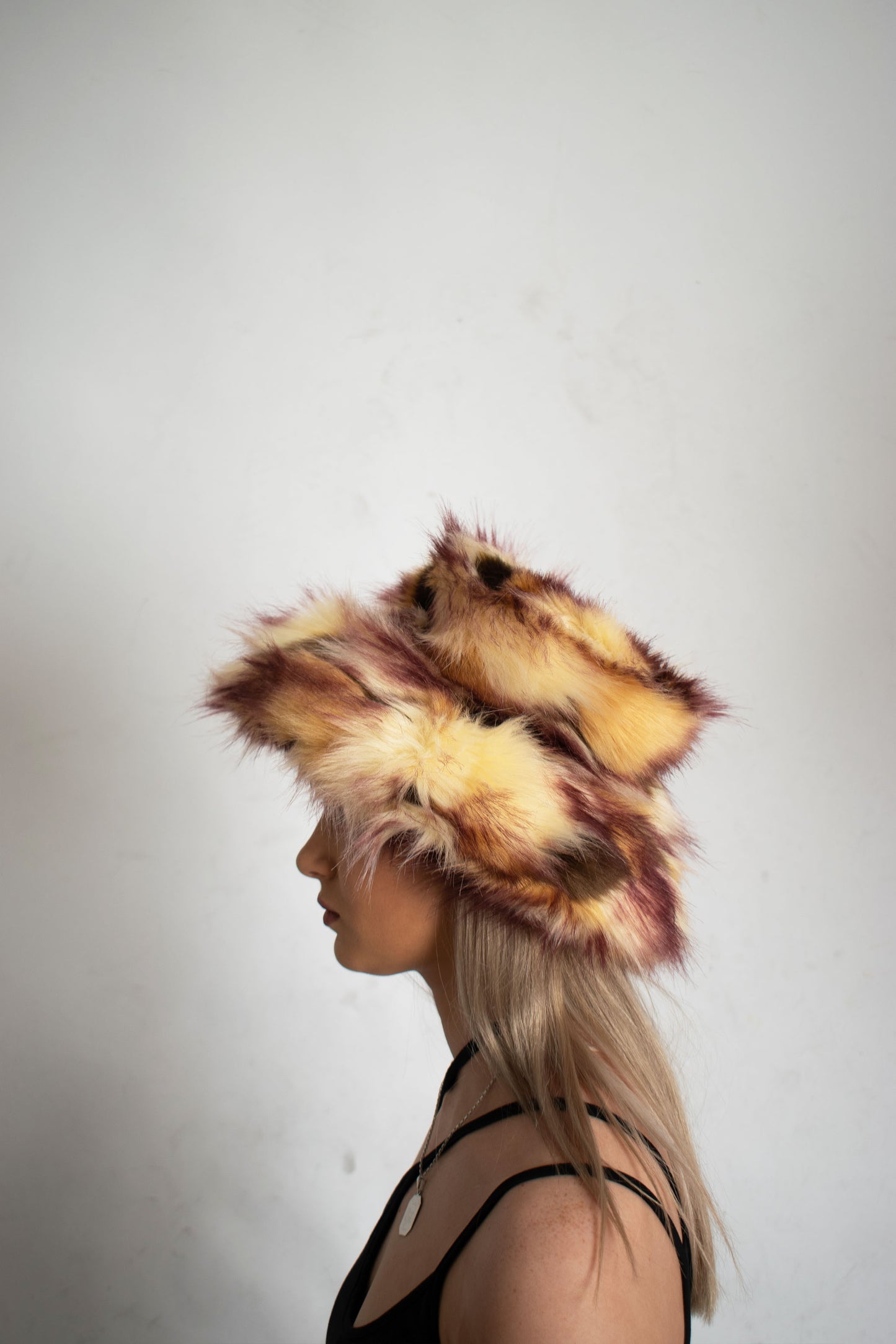 This unique style of hat comes with a blend of colours, Beige, Brown, Cream, Burgundy and Light Burgundy Lining. Handmade from faux fur and duchess satin by Rashhiiid, an Irish fashion business that celebrates individualism and sustainable fashion. This headpiece is a stylish example of alternative fashion design that is both high quality and ethical.