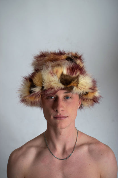 This unique style of hat comes with a blend of colours, Beige, Brown, Cream, Burgundy and Light Burgundy Lining. Handmade from faux fur and duchess satin by Rashhiiid, an Irish fashion business that celebrates individualism and sustainable fashion. This headpiece is a stylish example of alternative fashion design that is both high quality and ethical.