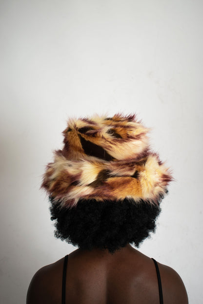This unique style of hat comes with a blend of colours, Beige, Brown, Cream, Burgundy and Light Burgundy Lining. Handmade from faux fur and duchess satin by Rashhiiid, an Irish fashion business that celebrates individualism and sustainable fashion. This headpiece is a stylish example of alternative fashion design that is both high quality and ethical.